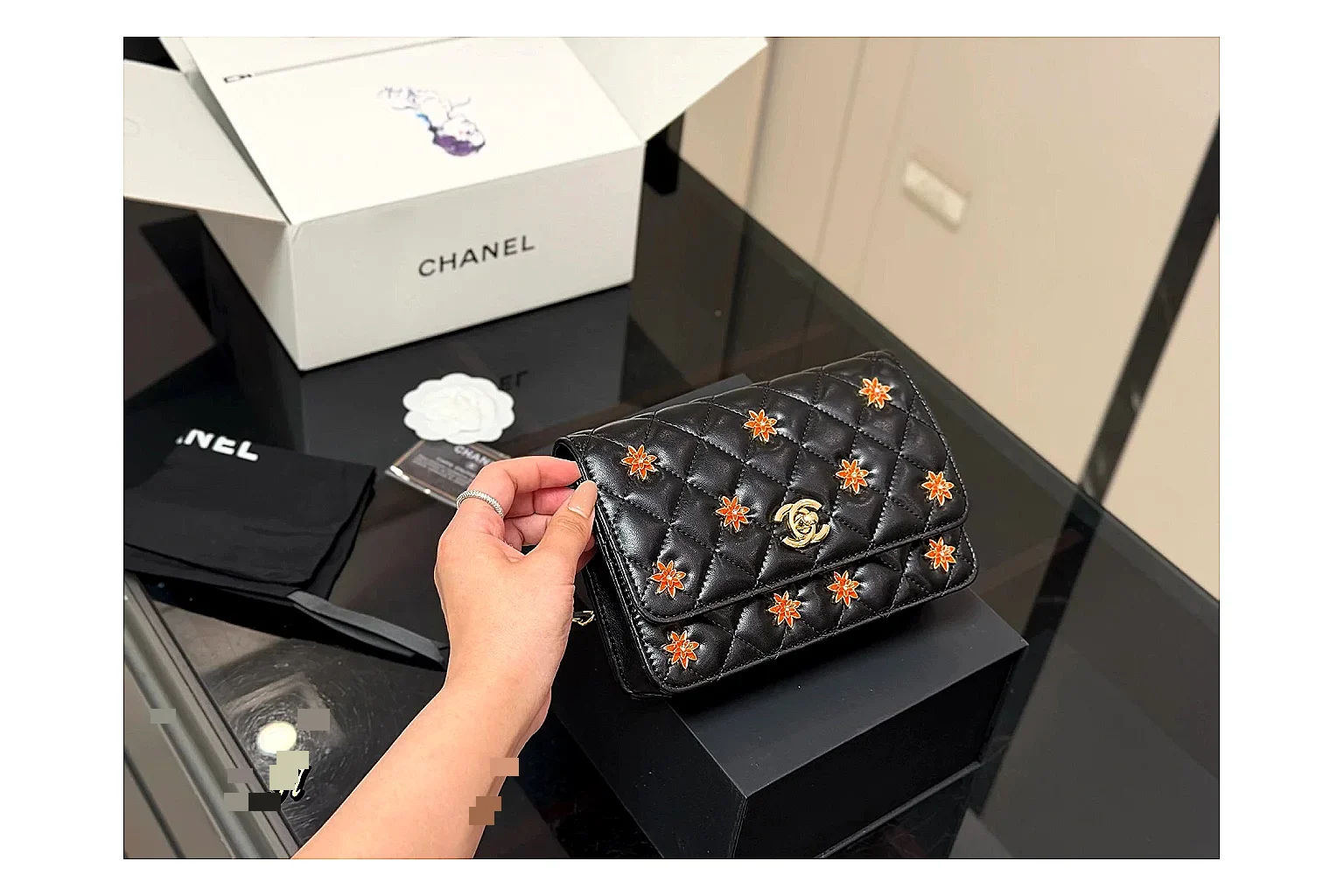 Chanel Quilted Wallet Bag Black Floral OOPBuy route photo showing black quilted wallet-bag body, floral detail, compact flap shape, and polished chain hardware