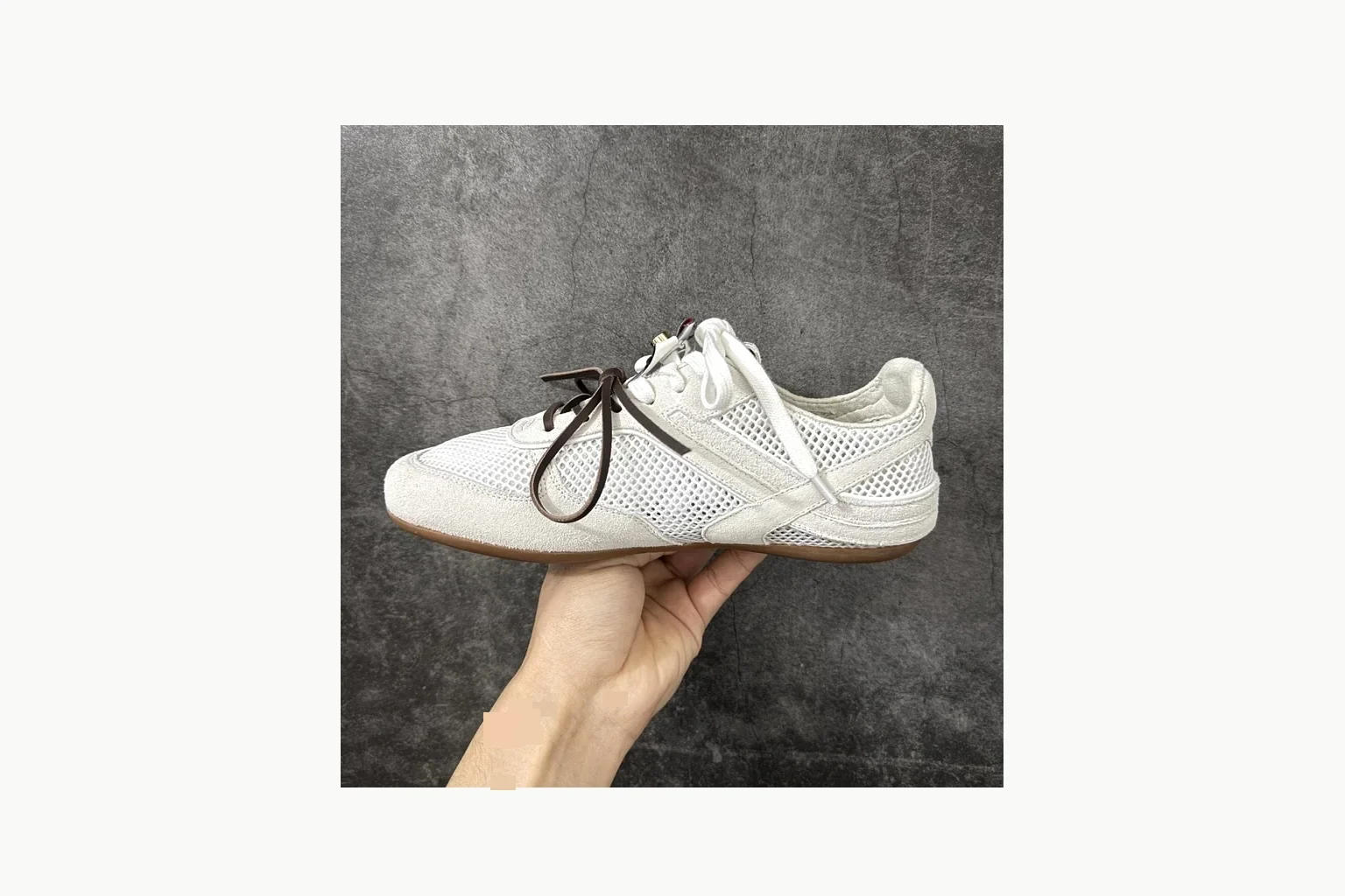 White Miu Miu low-top sneaker with bow detail, toe, heel, and sole