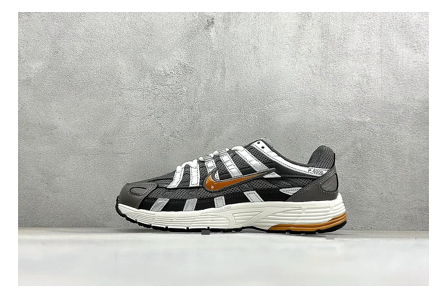 Nike P-6000 Black Orange OOPBuy route photo showing black layered runner upper, orange accent hits, retro P-6000 paneling, and cushioned casual sole