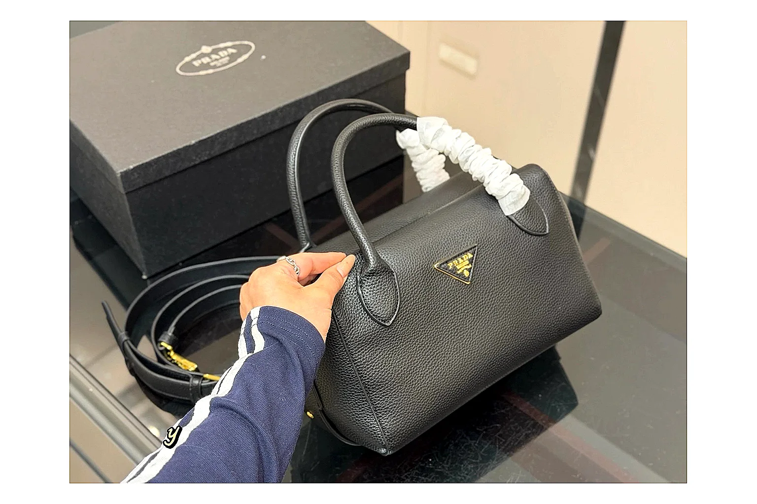 Prada Mini Top Handle Black OOPBuy route photo showing black leather mini bag body, structured top handle, compact silhouette, and clean metal hardware thumbnail 2