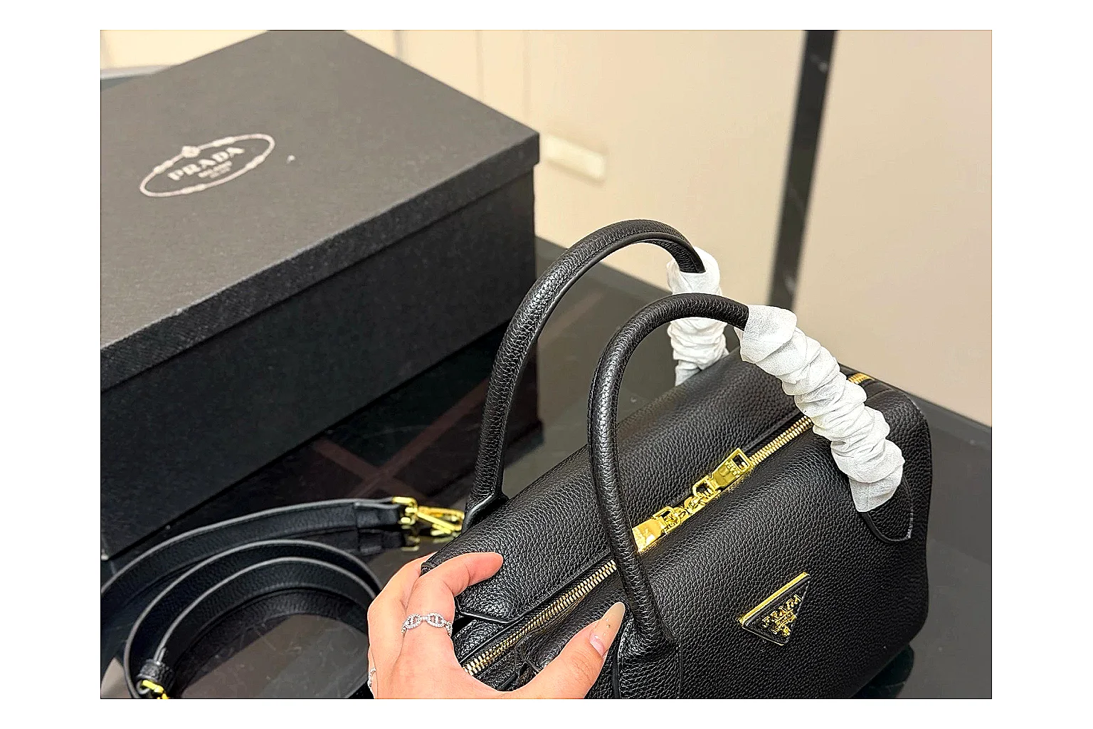 Prada Mini Top Handle Black OOPBuy route photo showing black leather mini bag body, structured top handle, compact silhouette, and clean metal hardware thumbnail 3